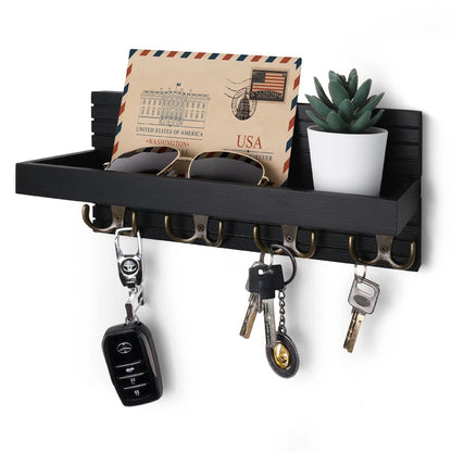 Black wall-mounted shelf with key holder, sunglasses, and decorative items on a white background
