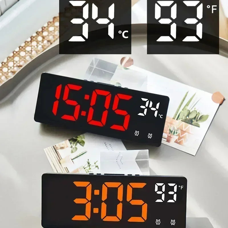 Digital clock displaying time and temperature on a table with a magazine.