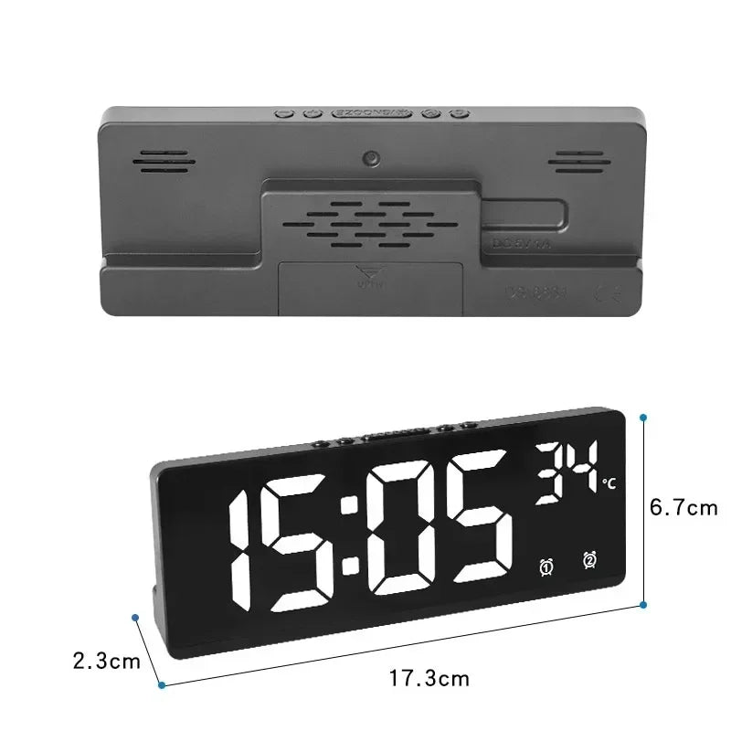 Black digital clock with measurements on a white background