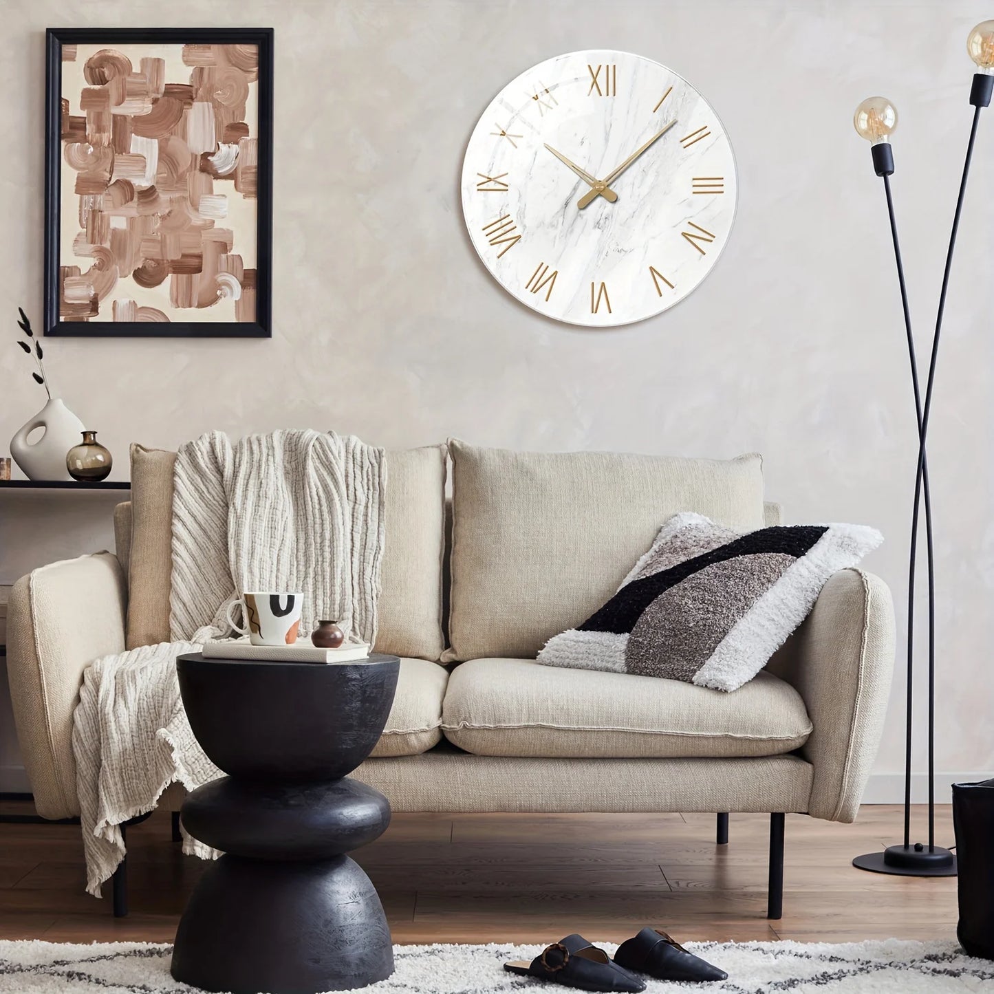 Living room with a beige sofa, black side table, and decorative wall clock.