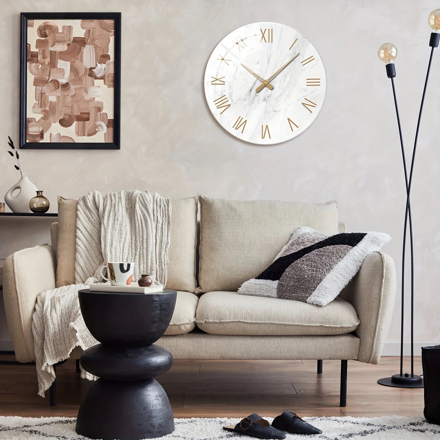 Living room with a beige sofa, black side table, and decorative wall clock.