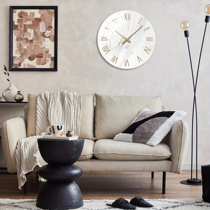 Living room with a beige sofa, black side table, and decorative wall clock.